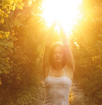 Frau in Yoga-Asana in der Sonne